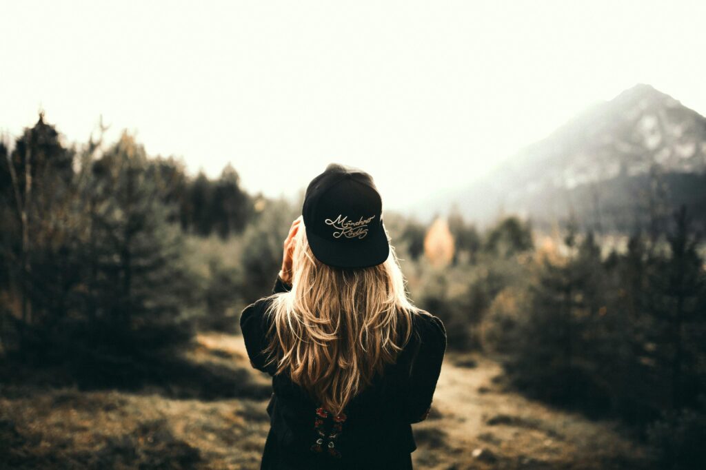 Back View of a Woman Black Sweater and Black Cap